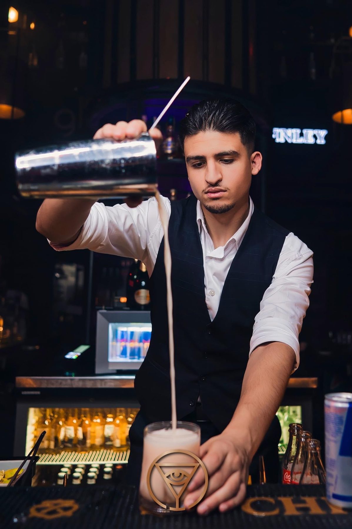 Abdellah Daha mixing a cocktail behind the bar
